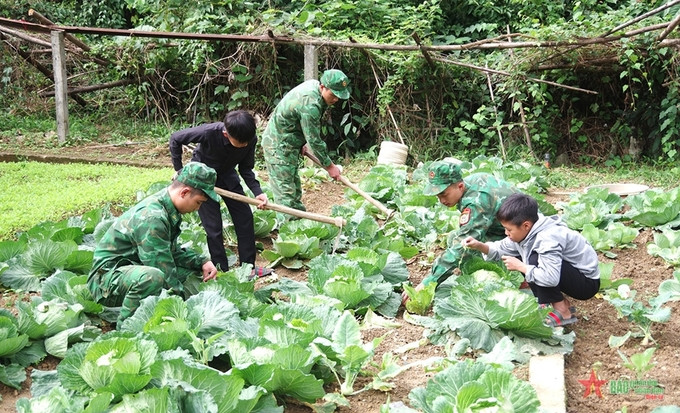 Các em được tham gia tăng gia sản xuất cùng cán bộ, chiến sĩ Đồn Biên phòng Sơn Vĩ (Bộ đội Biên phòng tỉnh Hà Giang). Ảnh: Báo Quân đội nhân dân