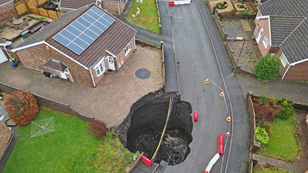 The crater extends to just feet away from one home's front door