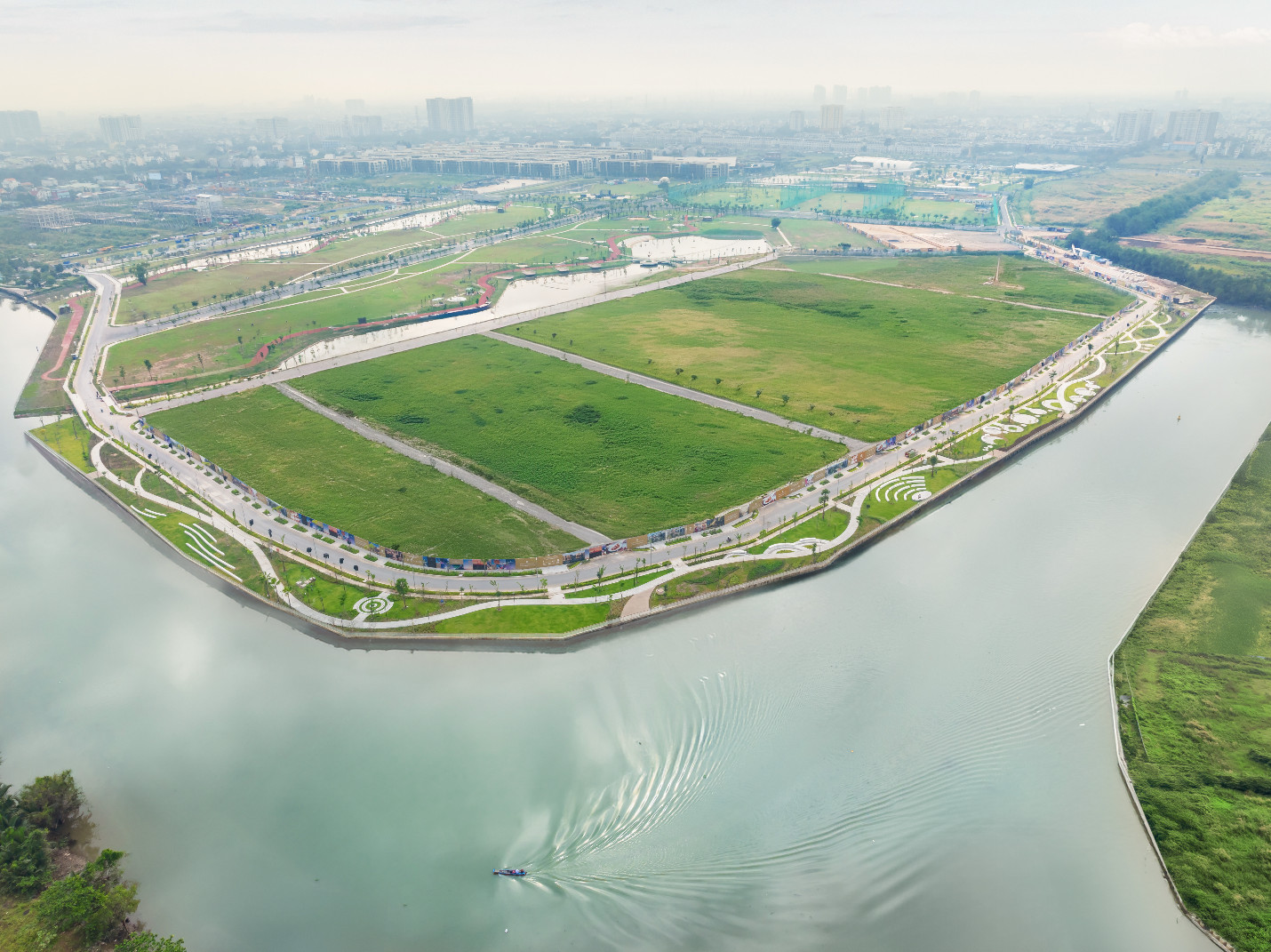 A green land with a body of water AI-generated content may be incorrect.