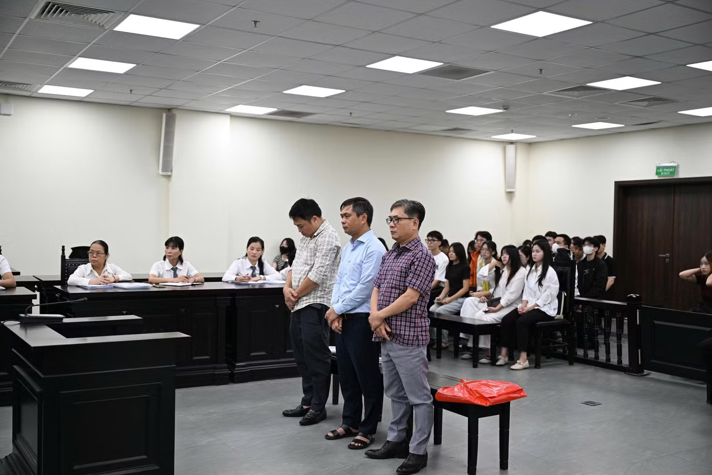 Bị cáo Phạm Văn Long (áo xanh đứng giữa) và hai đồng phạm Nguyễn Tuấn Ngọc và Nguyễn Văn Sáng. Cựu hiệu trưởng 'ăn chặn' tiền hỗ trợ A80 của gần 1.000 sinh viên bị tuyên án 3 năm tù - Ảnh 1.