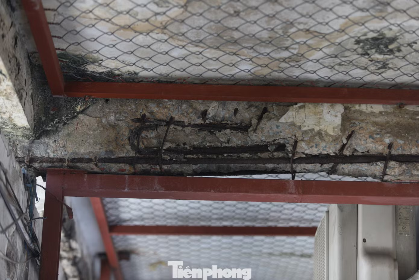Một số khu vực được gia cố tạm bằng thanh sắt, lưới bảo vệ nhằm hạn chế nguy cơ bê tông rơi xuống. Hàng trăm người 'bám trụ' trong khu chung cư chờ sập ở TPHCM - Ảnh 5.