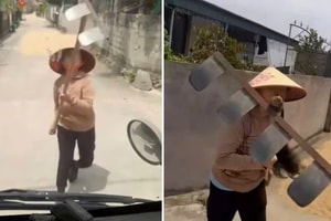 Phơi lúa lấn đường, người phụ nữ dùng cào chặn xe tải, tấn công tài xế